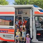 Kinder entdecken mit Rettungssanitätern einen Rettungswagen &copy;EGem Stadt Tangerhütte