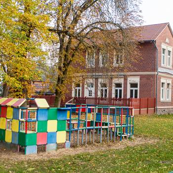 Kindertageseinrichtung "Unsere Dorfspatzen" Lüderitz mit Spielgerät im Vordergrund