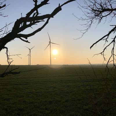 Windräder in der Abenddämmerung auf einem Feld in der Einheitsgemeinde